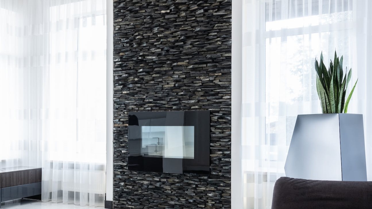 a tiny electric fireplace with minimal surround mounted on wall