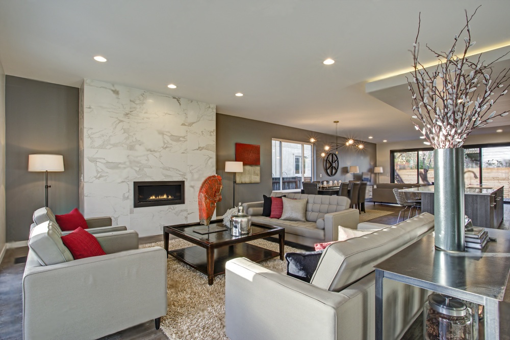 fireplace surrounded with marble in a beautiful living room